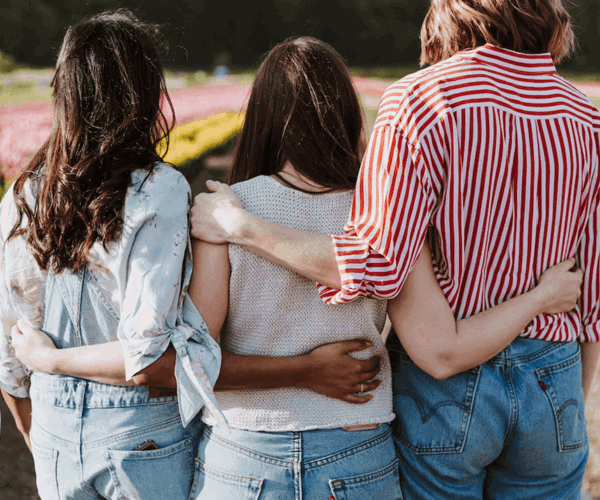 Row Of Three Ladies With Arms Around Each Other