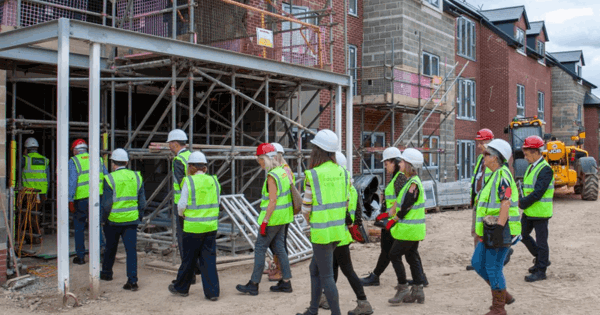 A Group Of People In PPE On Construction Site