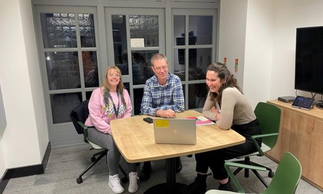 Staff And Tenant Group Member Sitting At A Desk