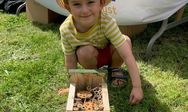 Child Posing With Bug Hotel