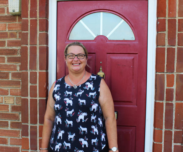 Happy Tenant In Front Of Red Door