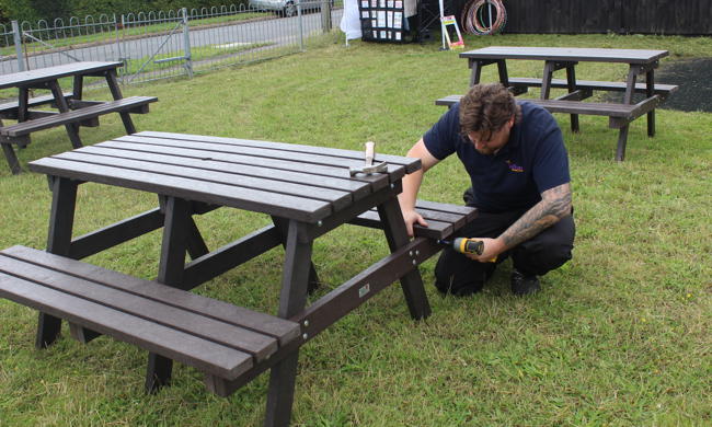 Craftworker Installing Picnic Bench