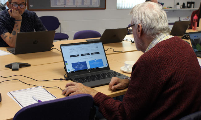 Two Men Working At Laptops